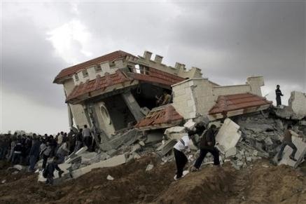 3291618862-palestinians-gather-around-the-damaged-house-of-the-fayyad-family.jpg