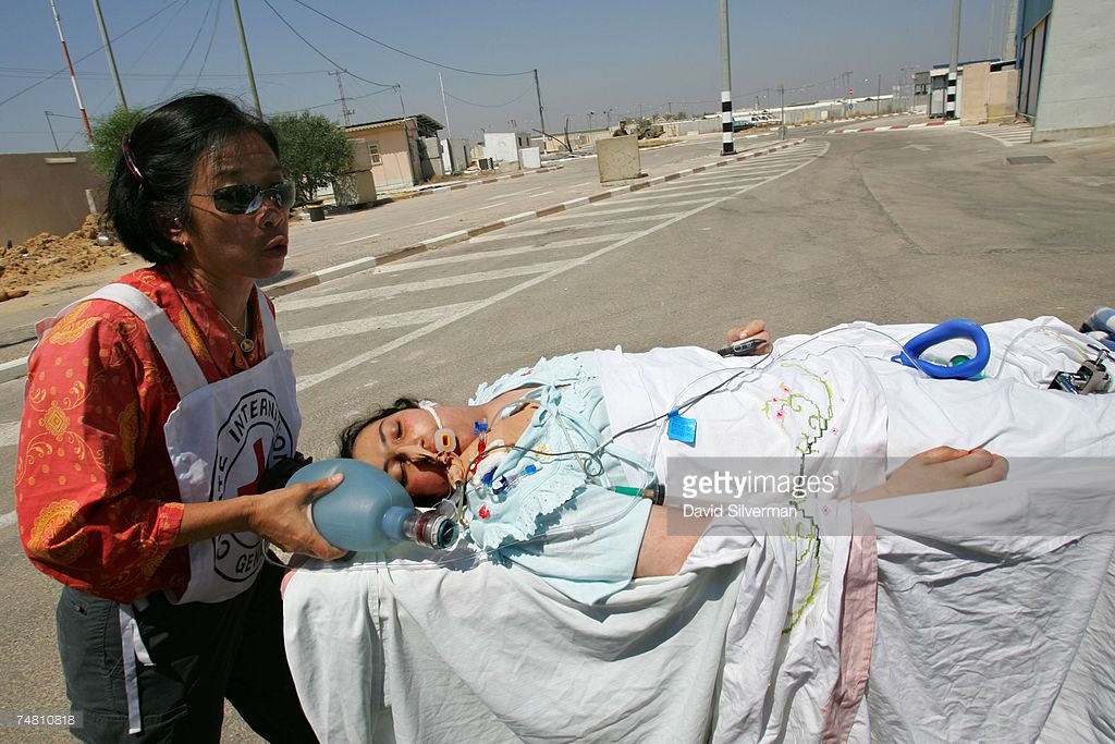 74810818-red-cross-official-evacuates-a-critically-ill-getty.jpg