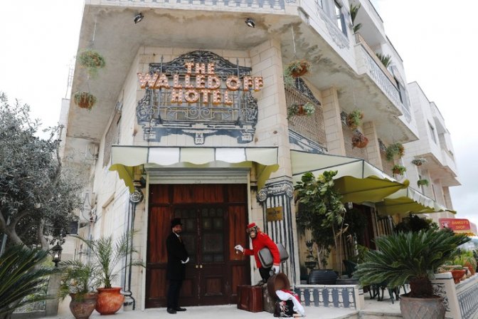 groom-tient-devant-hotel-walled-off-recemment-ouvert-banksy-bethleem-territoires-palestiniens-jouxtant-separation-construit-israel-3-2017_0_729_486.jpg